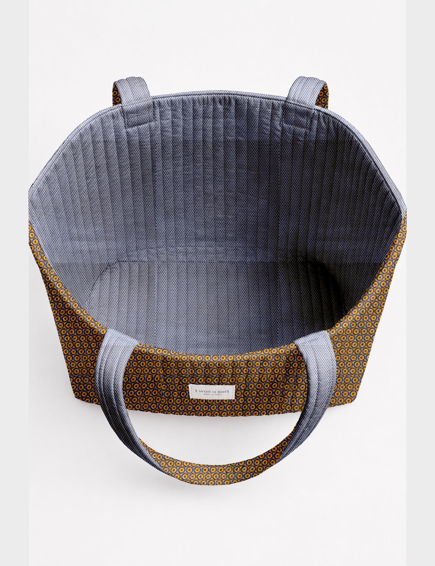 Large quilted beach bag with spacious rectangular design, reinforced shoulder straps, and open-top construction for everyday use and travel.