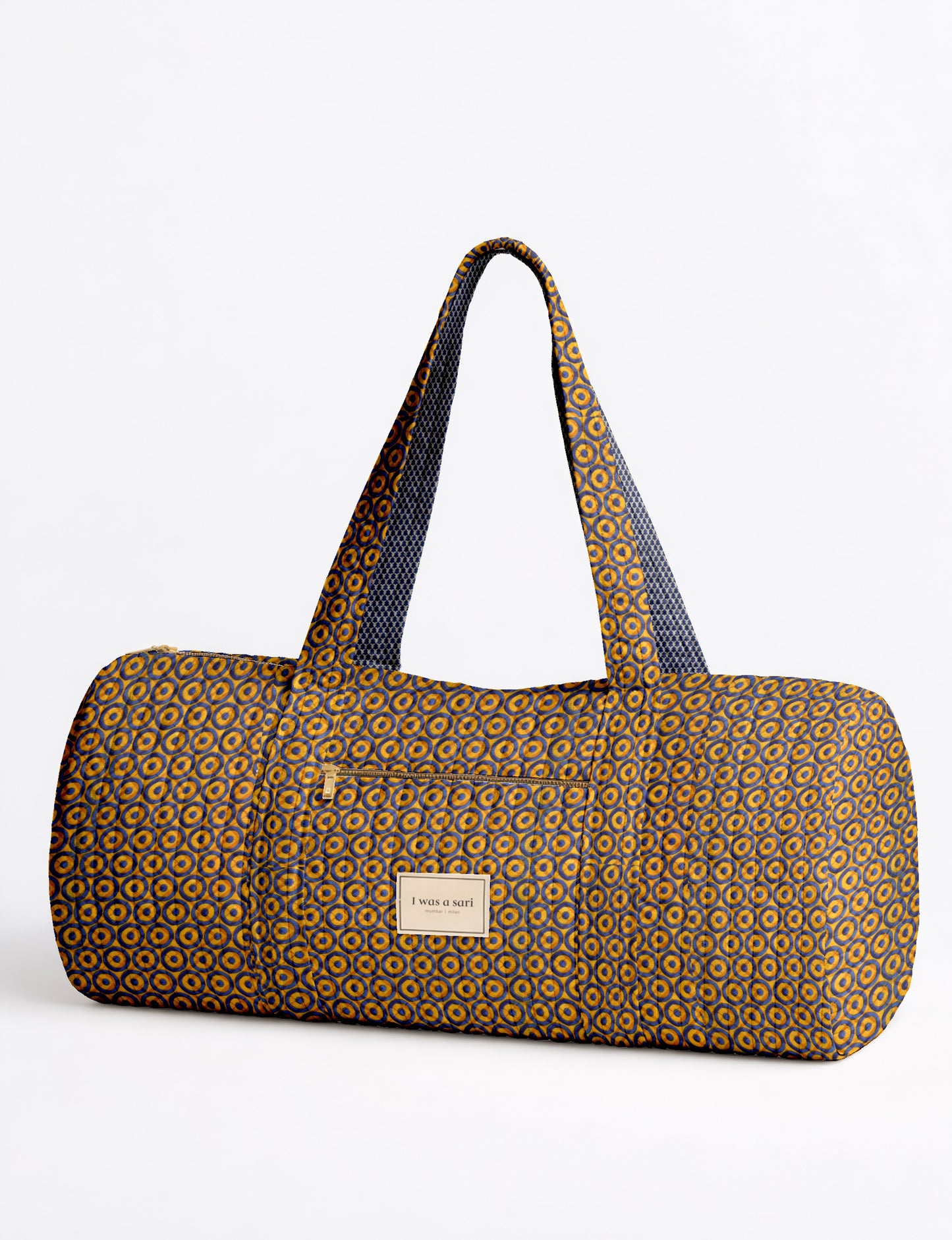 Beige quilted bowling bag with micro floral pattern, front zipper pocket, and dual handles with striped inner lining