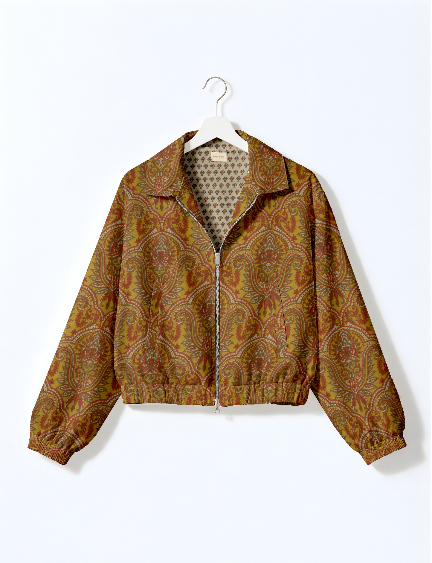 Upcycled Bomber Jacket made from recycled sari materials, featuring a cute cropped shape, elasticated hem and cuffs, and contrast sari print lining. Sustainable apparel promoting eco-friendly fashion and ethical clothing.