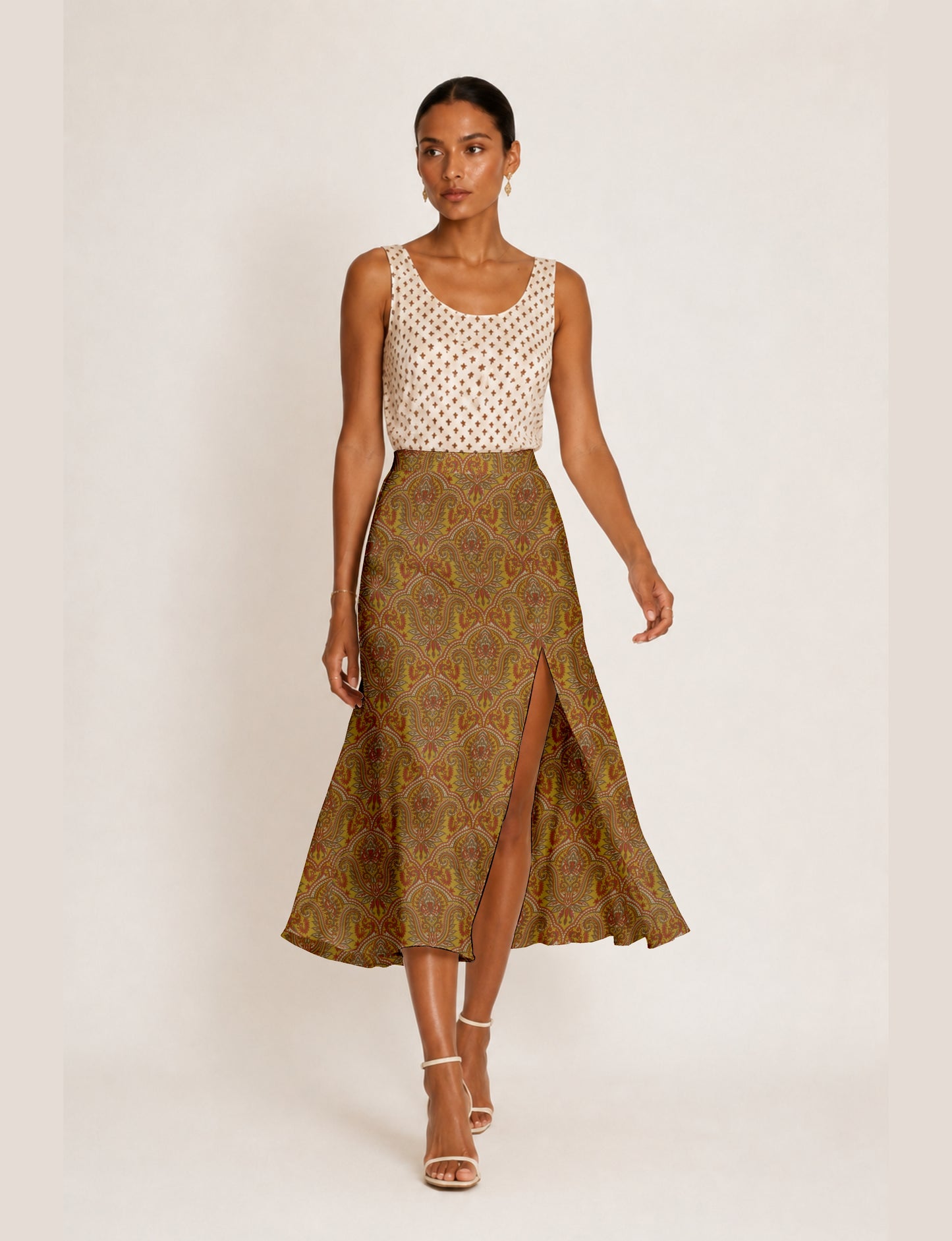 Midi A-line skirt with front slit, fitted waistband, concealed side closure, and below mid-calf length silhouette.