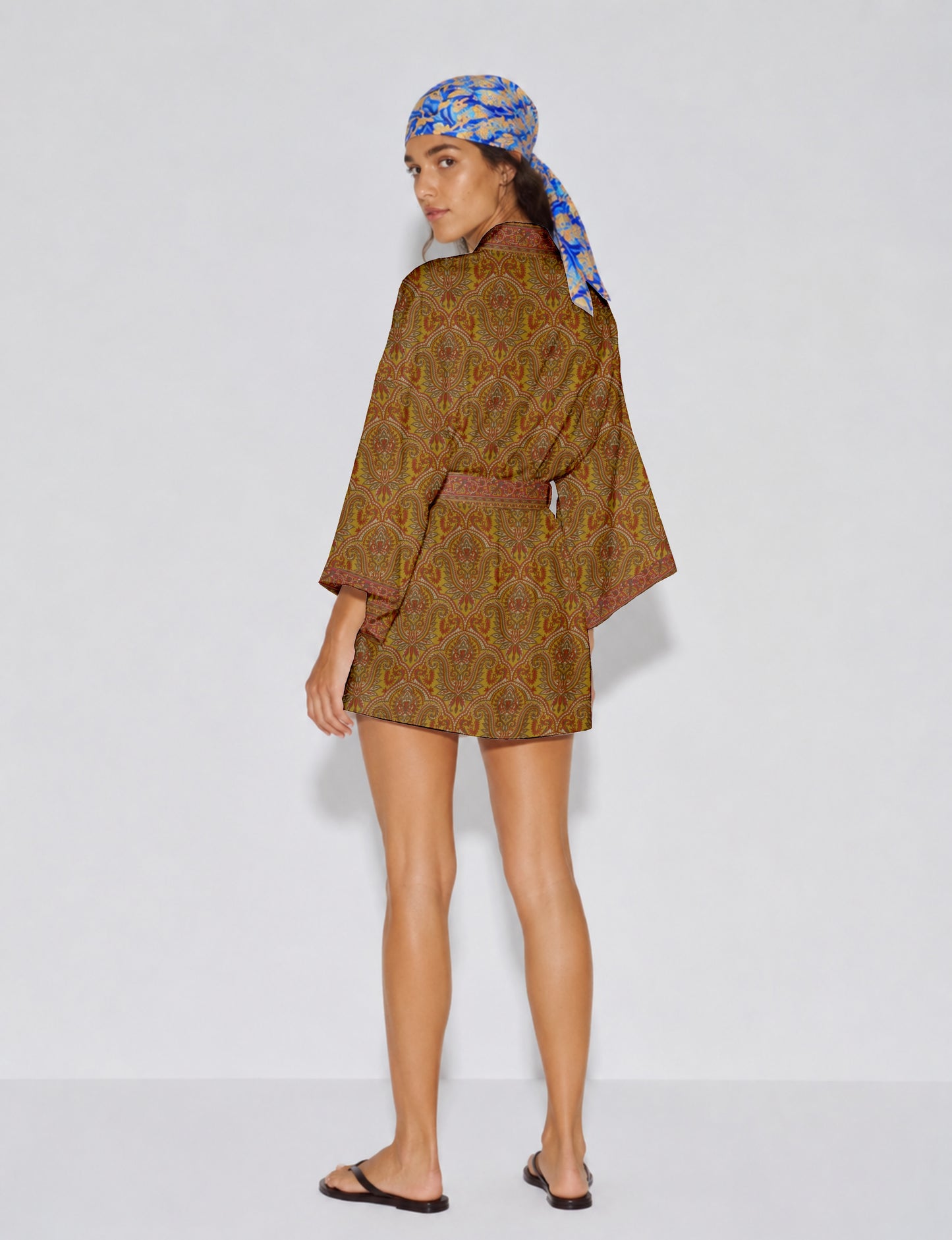 Short kimono robe with wrap front, V-neckline, wide sleeves, waist tie, and concealed skort detail.