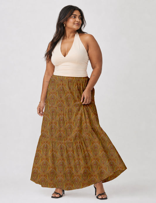 Midi tiered skirt with fitted waistband, soft knife pleats, flared silhouette, side seam pockets, and ankle-length hem