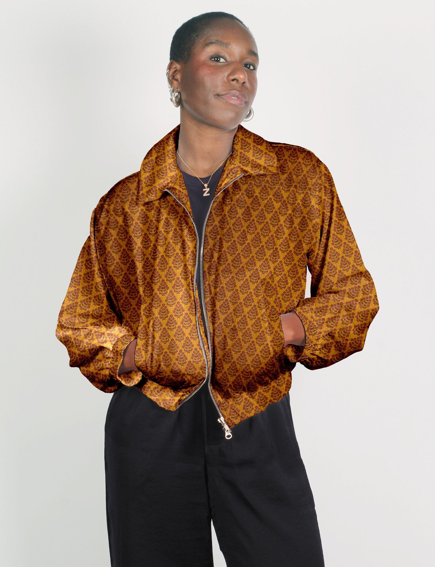 Upcycled Bomber Jacket made from recycled sari materials, featuring a cute cropped shape, elasticated hem and cuffs, and contrast sari print lining. Sustainable apparel promoting eco-friendly fashion and ethical clothing.