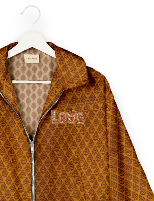 Love Bomber Jacket made from recycled fabric, featuring hand-stitched Aari embroidery. A unique piece of zero-waste clothing, part of the circular fashion movement. Designed with upcycled materials for a stylish yet environmentally friendly clothing choice.