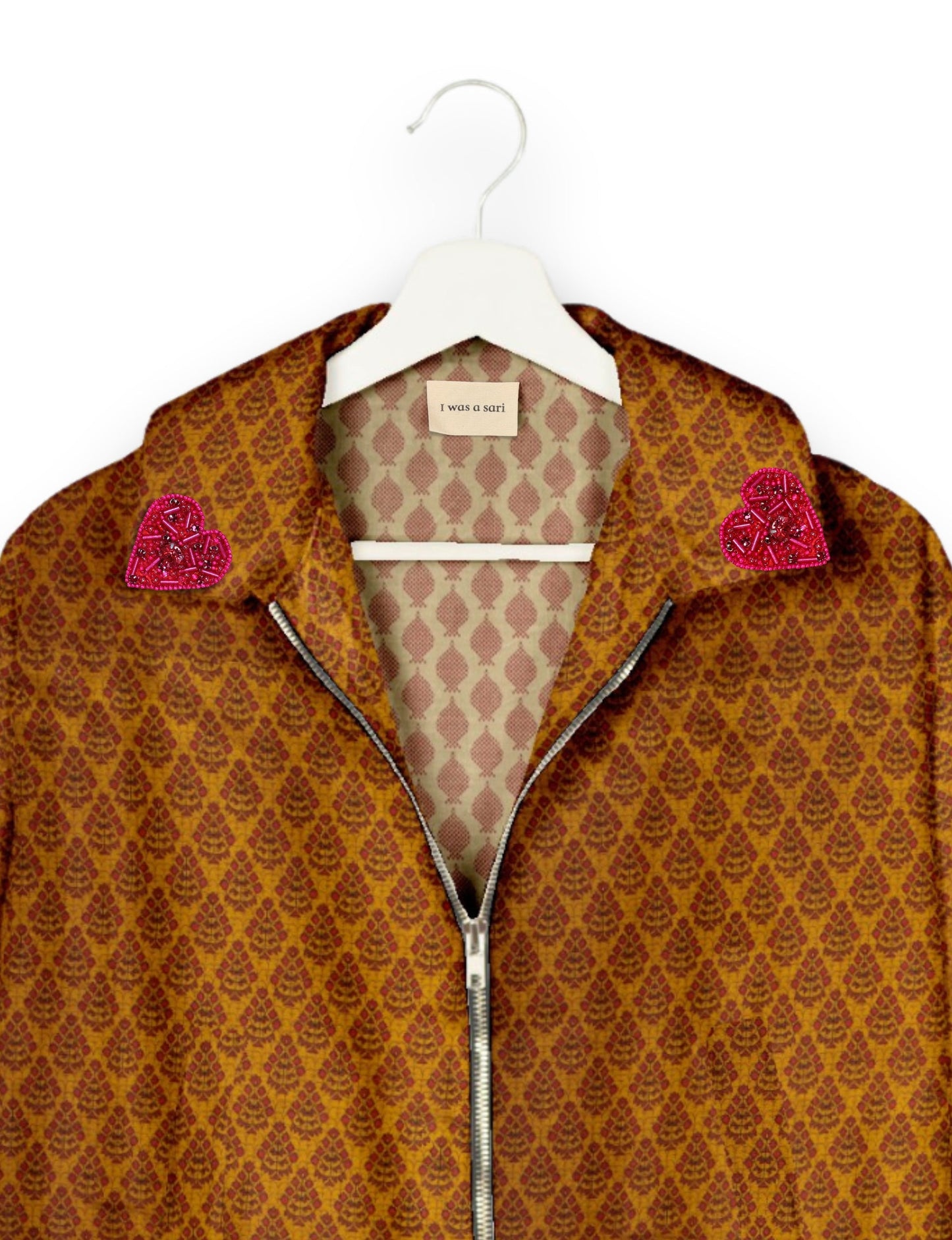 Make a bold statement with our Heart Drop Earrings, a symbol of conscious luxury and ethical fashion. Handcrafted using the intricate Aari embroidery technique, these earrings are made from upcycled sari fabric, embracing slow fashion and zero waste clothing. Elevate your look with sustainable apparel that supports fair trade fashion while reducing textile waste. Choose eco-friendly fashion that speaks of love, artistry, and responsibility.