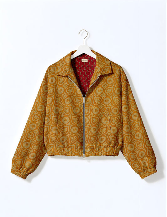 Yellow bomber jacket with floral and leaf pattern, front zipper, elastic cuffs and hem, red patterned inner lining, hanging