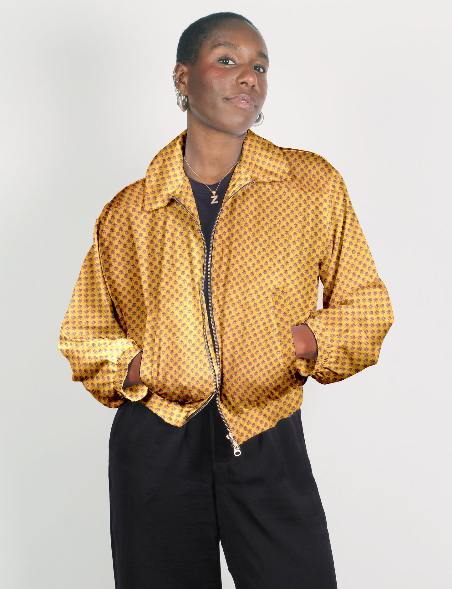 Upcycled Bomber Jacket made from recycled sari materials, featuring a cute cropped shape, elasticated hem and cuffs, and contrast sari print lining. Sustainable apparel promoting eco-friendly fashion and ethical clothing.