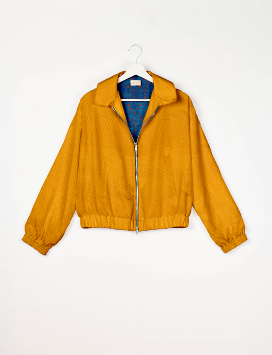 Upcycled Bomber Jacket made from recycled sari materials, featuring a cute cropped shape, elasticated hem and cuffs, and contrast sari print lining. Sustainable apparel promoting eco-friendly fashion and ethical clothing.