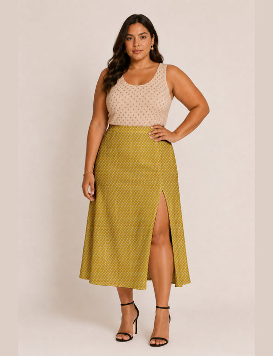 Woman wearing a yellow and black micro patterned A-line skirt with front slit, paired with beige sleeveless top and black