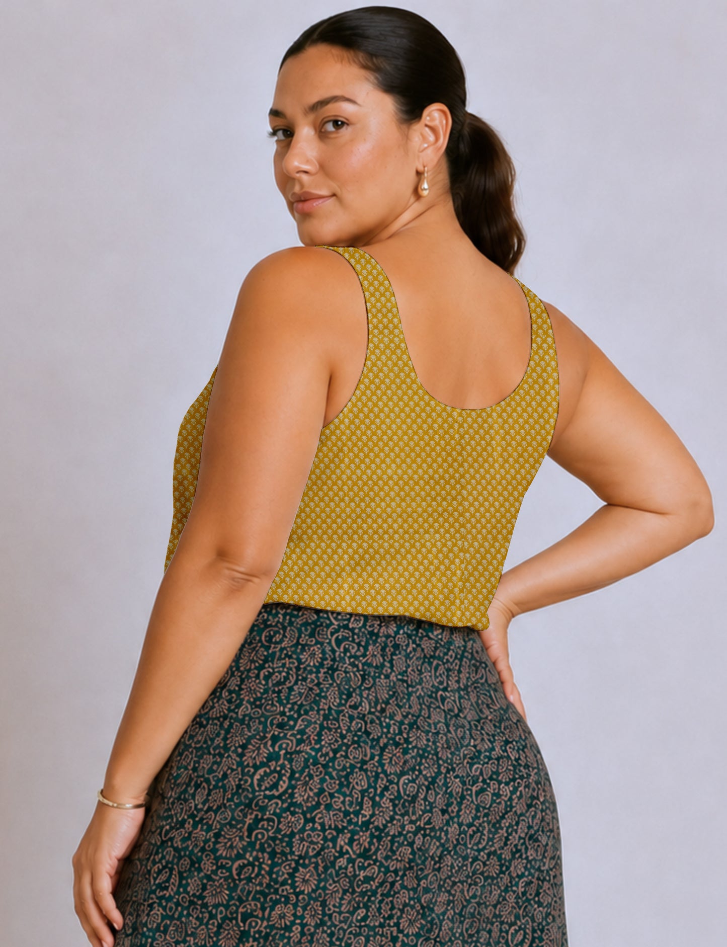 Women's sleeveless blouse with a relaxed straight fit, wide scoop neckline, deep scoop back, and hip-length silhouette.