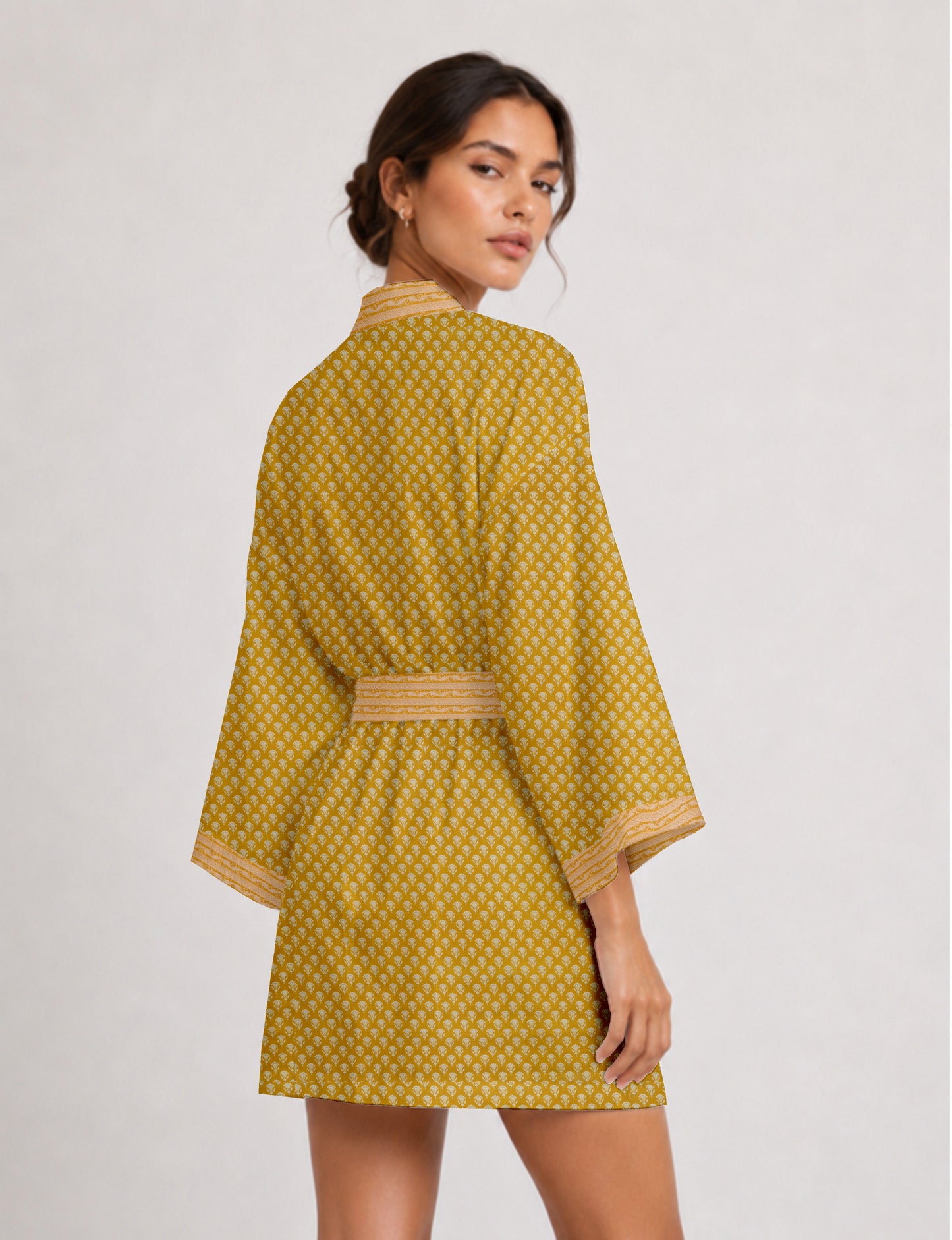 Short kimono robe with wrap front, V-neckline, wide sleeves, waist tie, and concealed skort detail.