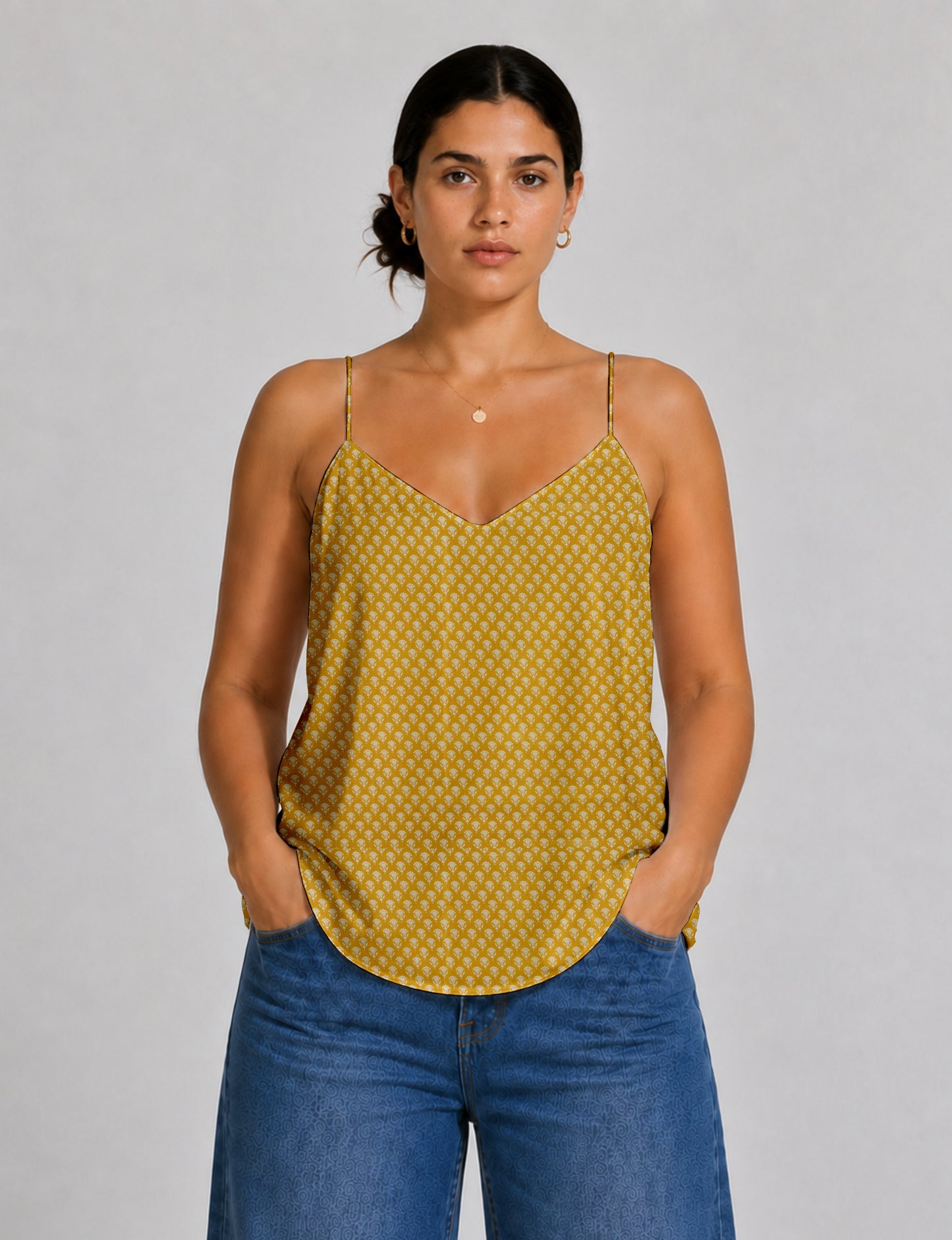Women's sleeveless slip top with a relaxed straight fit, soft V-neckline, deep V-back, and delicate spaghetti straps.