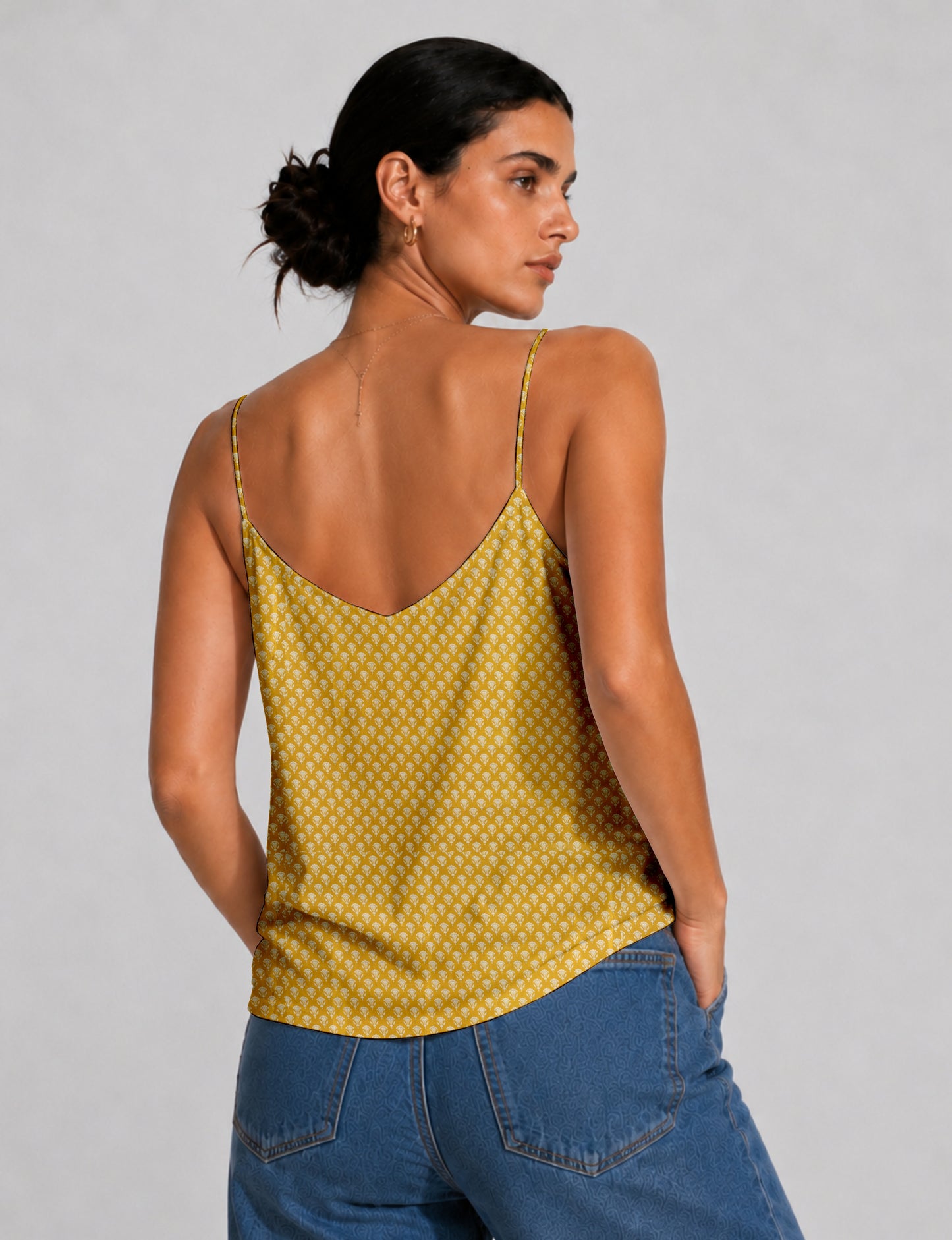 Women's sleeveless slip top with a relaxed straight fit, soft V-neckline, deep V-back, and delicate spaghetti straps.