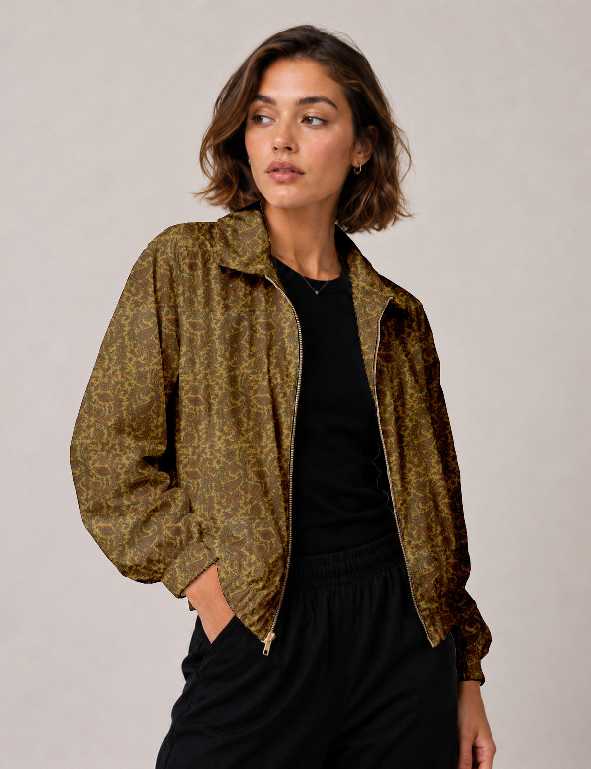 Woman wearing a yellow floral bomber jacket with front zipper, elastic cuffs, and side pockets, shown from front view