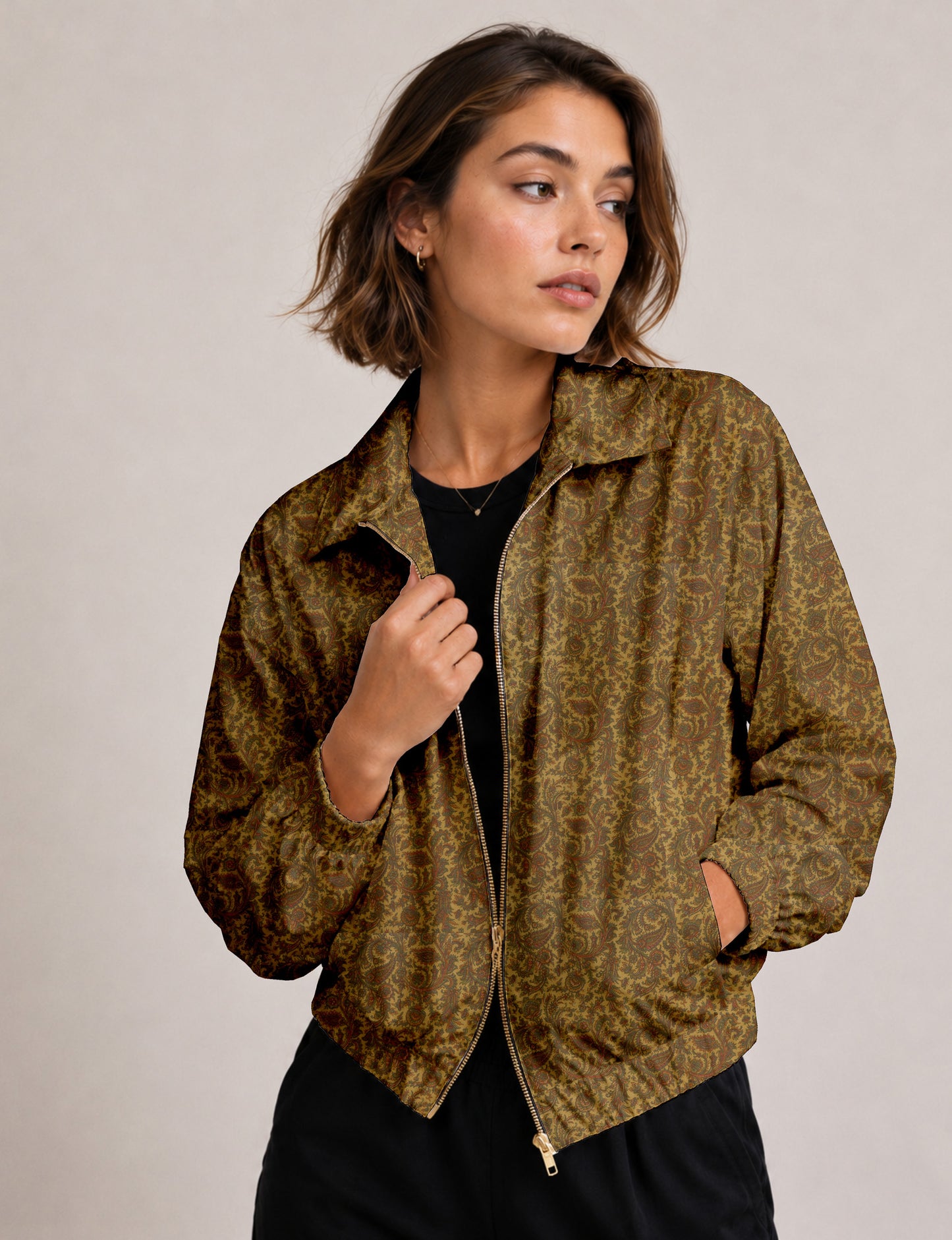 Woman wearing a yellow floral bomber jacket with front zipper, elastic cuffs, and side pockets, shown from front view