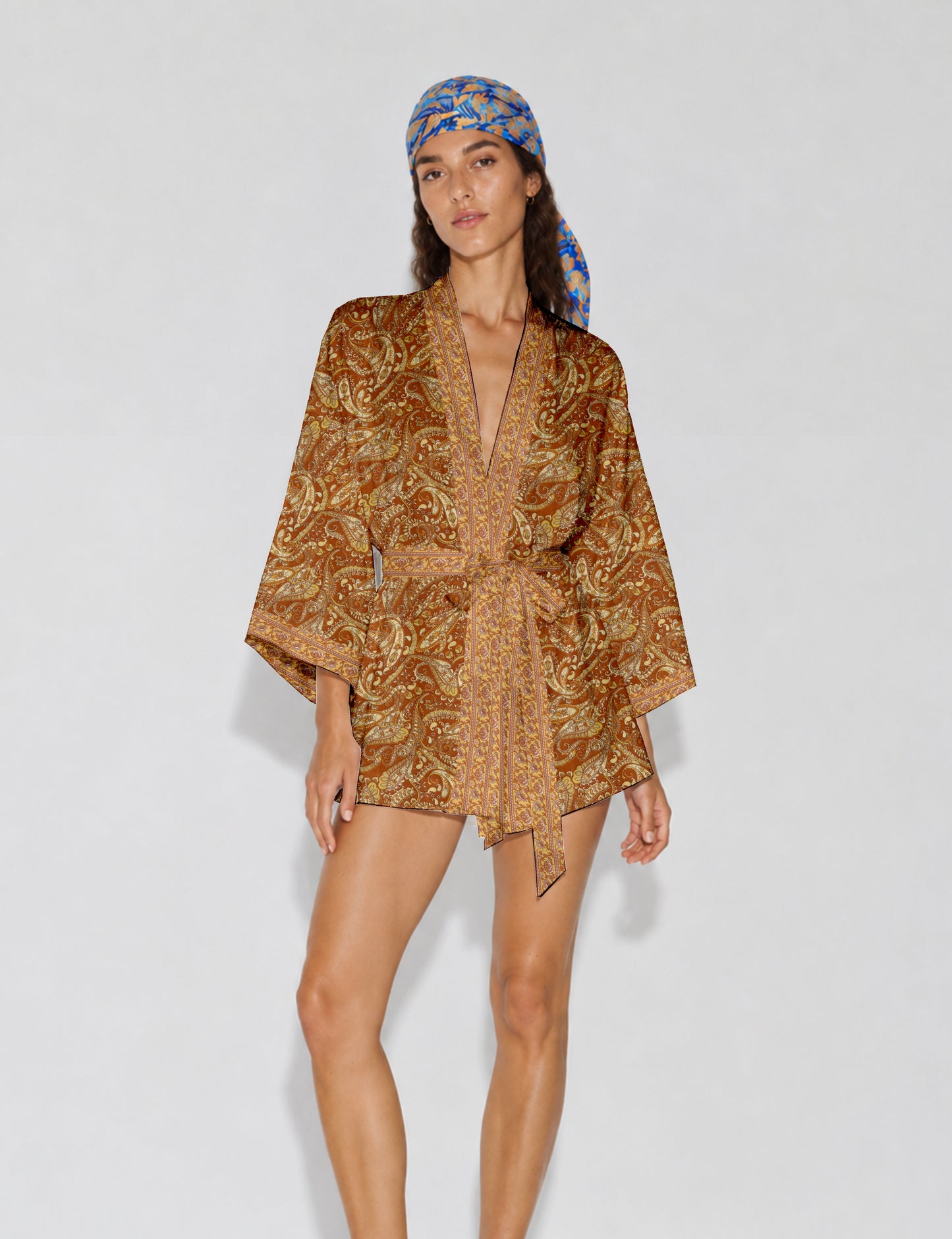 Short kimono robe with wrap front, V-neckline, wide sleeves, waist tie, and concealed skort detail.
