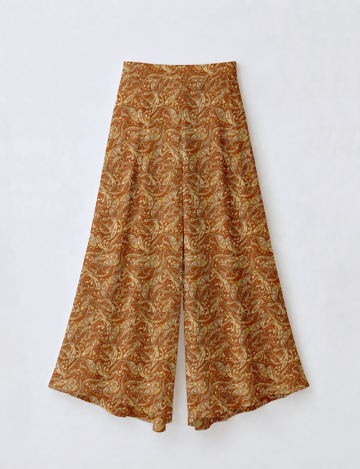 Yellow paisley wide leg palazzo trousers flat laid, featuring a high waist and flowing wide legs