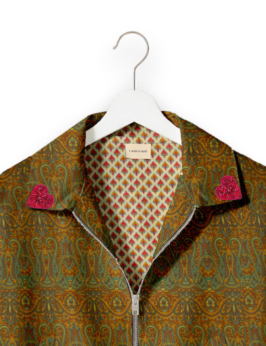 Make a bold statement with our Heart Drop Earrings, a symbol of conscious luxury and ethical fashion. Handcrafted using the intricate Aari embroidery technique, these earrings are made from upcycled sari fabric, embracing slow fashion and zero waste clothing. Elevate your look with sustainable apparel that supports fair trade fashion while reducing textile waste. Choose eco-friendly fashion that speaks of love, artistry, and responsibility.