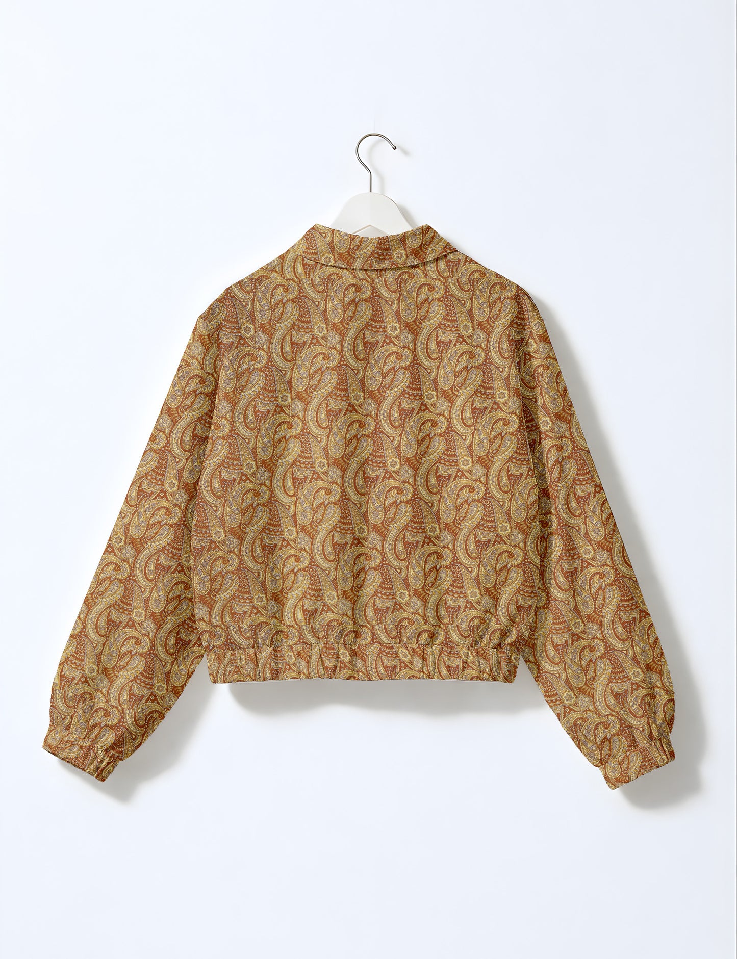 Women's cropped bomber jacket with twin metallic front zippers, welt pockets, elasticated hem and cuffs, and contrast sari print lining.