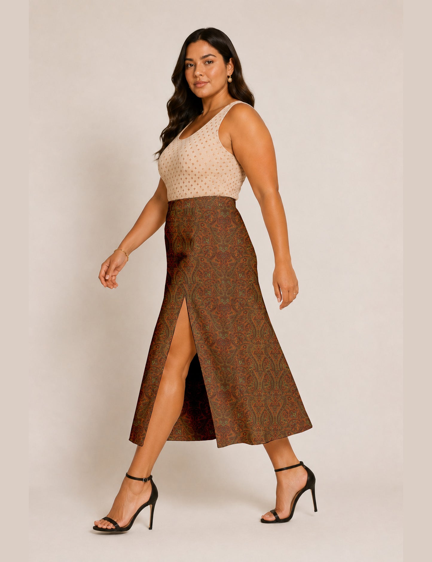 Woman wearing a yellow and black micro patterned A-line skirt with front slit, paired with beige sleeveless top and black