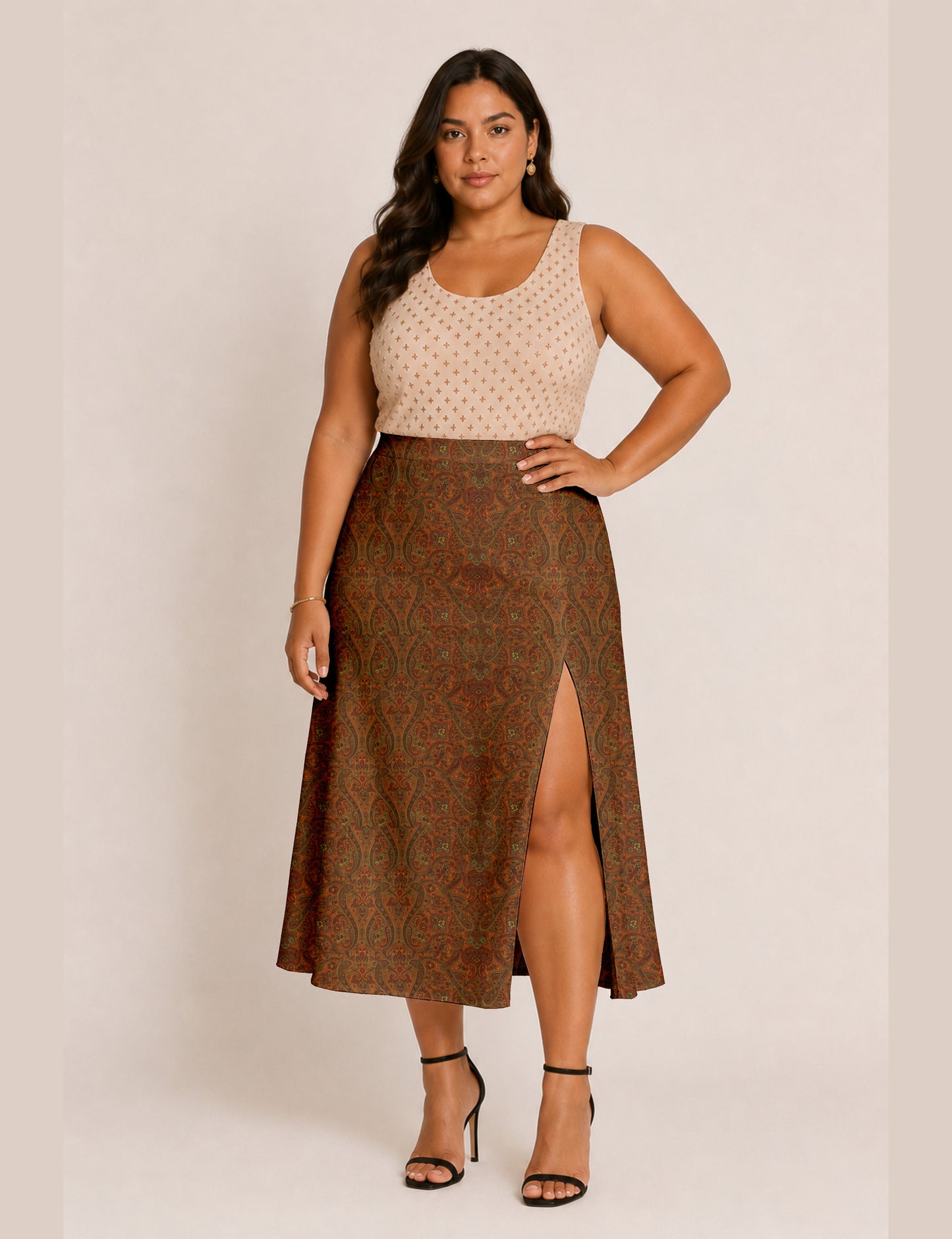 Woman wearing a yellow and black micro patterned A-line skirt with front slit, paired with beige sleeveless top and black
