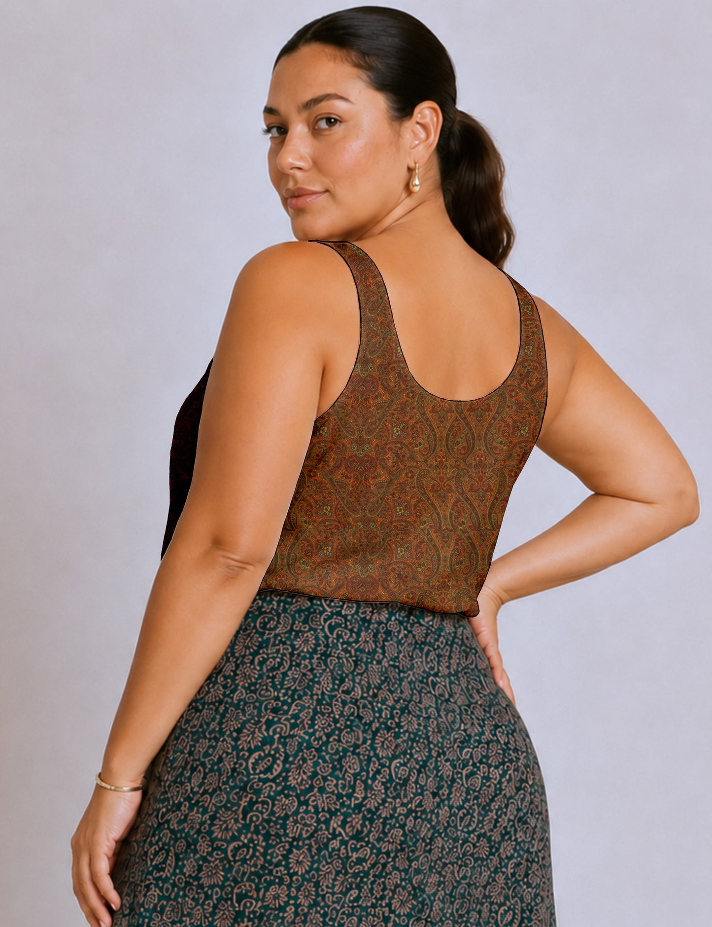 Women's sleeveless blouse with a relaxed straight fit, wide scoop neckline, deep scoop back, and hip-length silhouette.
