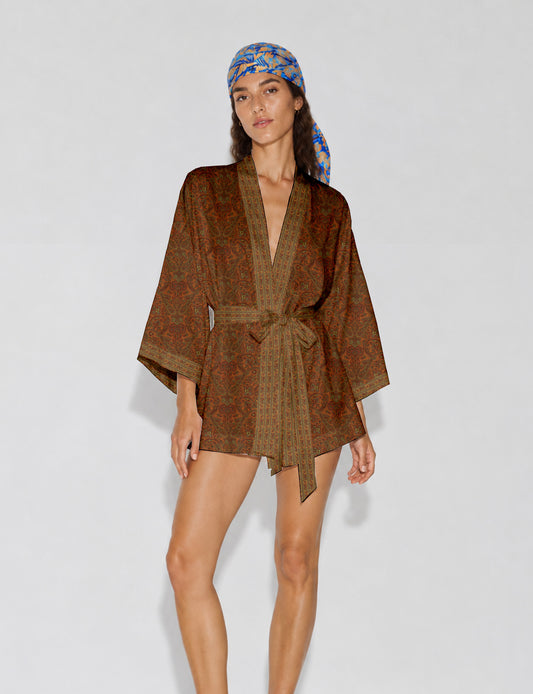 Short kimono robe with wrap front, V-neckline, wide sleeves, waist tie, and concealed skort detail.