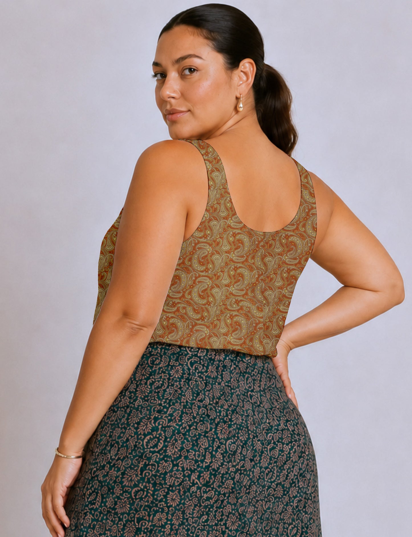 Women's sleeveless blouse with a relaxed straight fit, wide scoop neckline, deep scoop back, and hip-length silhouette.