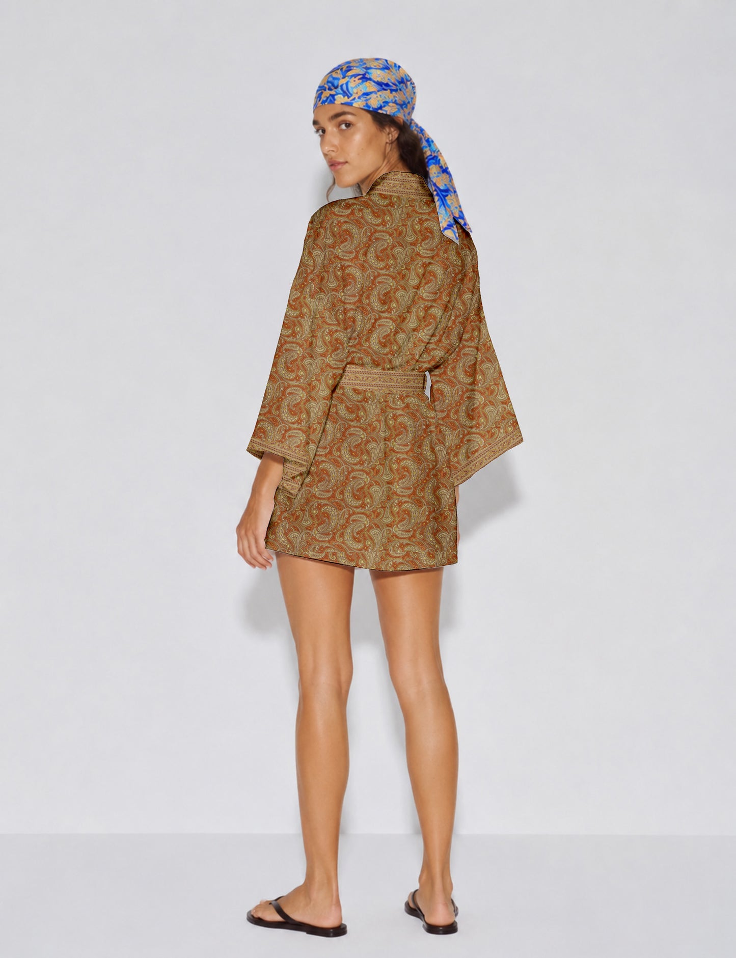 Short kimono robe with wrap front, V-neckline, wide sleeves, waist tie, and concealed skort detail.