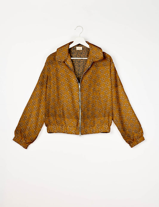 Upcycled Bomber Jacket made from recycled sari materials, featuring a cute cropped shape, elasticated hem and cuffs, and contrast sari print lining. Sustainable apparel promoting eco-friendly fashion and ethical clothing.