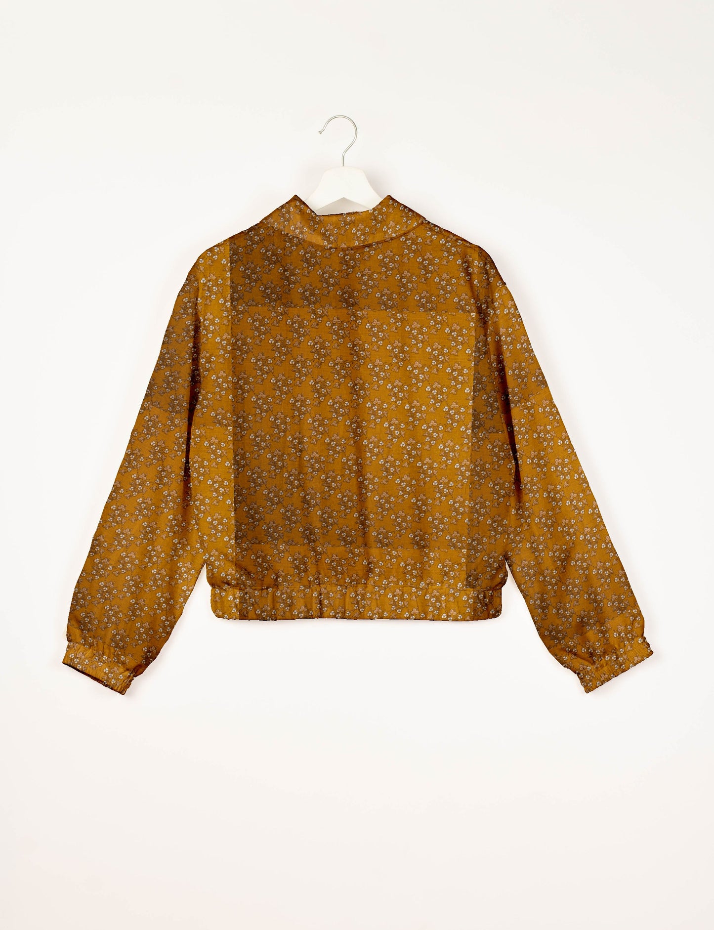 Upcycled Bomber Jacket made from recycled sari materials, featuring a cute cropped shape, elasticated hem and cuffs, and contrast sari print lining. Sustainable apparel promoting eco-friendly fashion and ethical clothing.