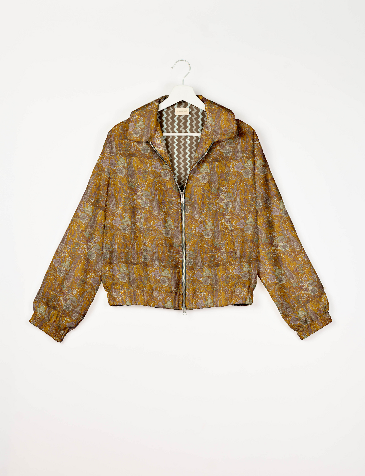 Upcycled Bomber Jacket made from recycled sari materials, featuring a cute cropped shape, elasticated hem and cuffs, and contrast sari print lining. Sustainable apparel promoting eco-friendly fashion and ethical clothing.