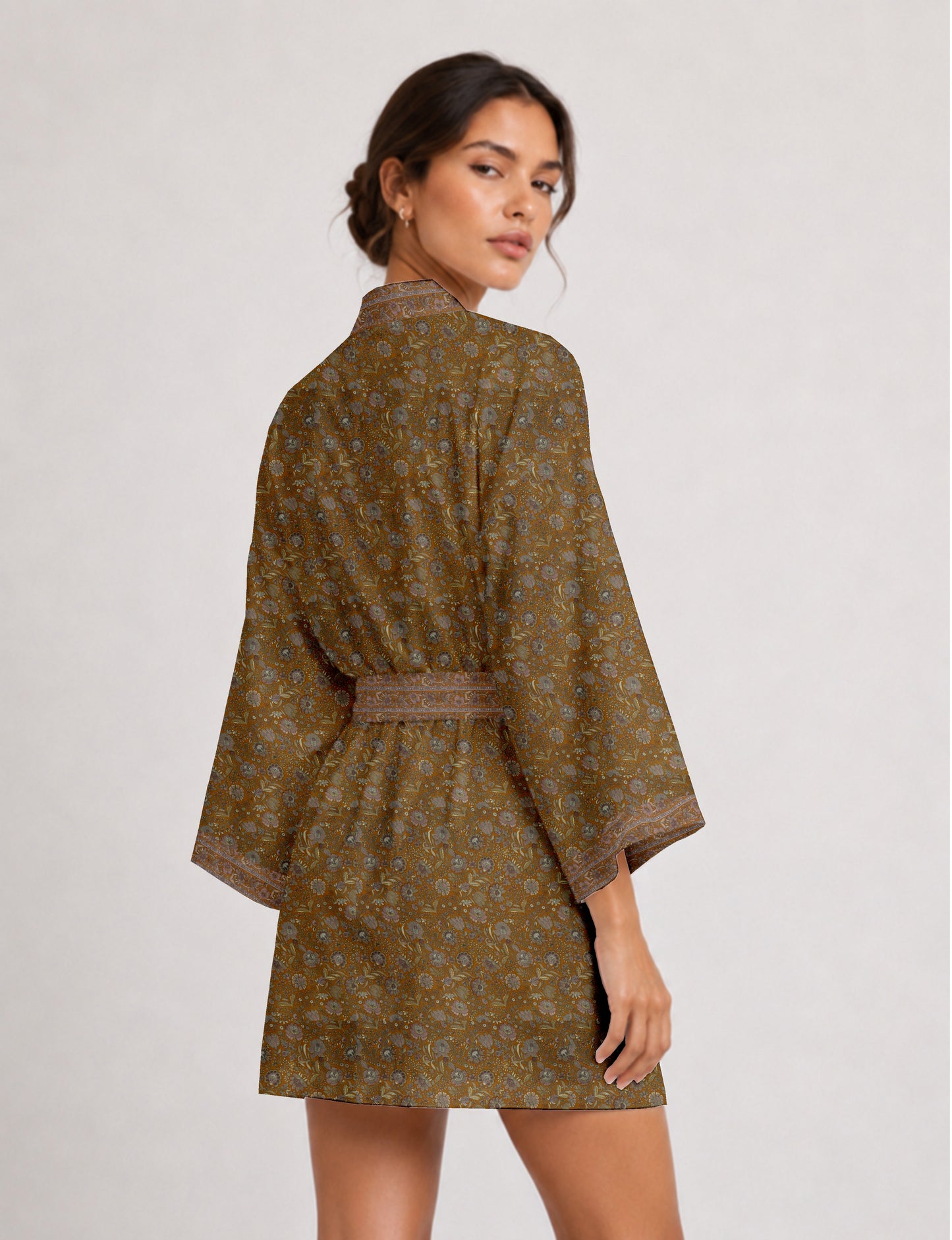 Short kimono robe with wrap front, V-neckline, wide sleeves, waist tie, and concealed skort detail.