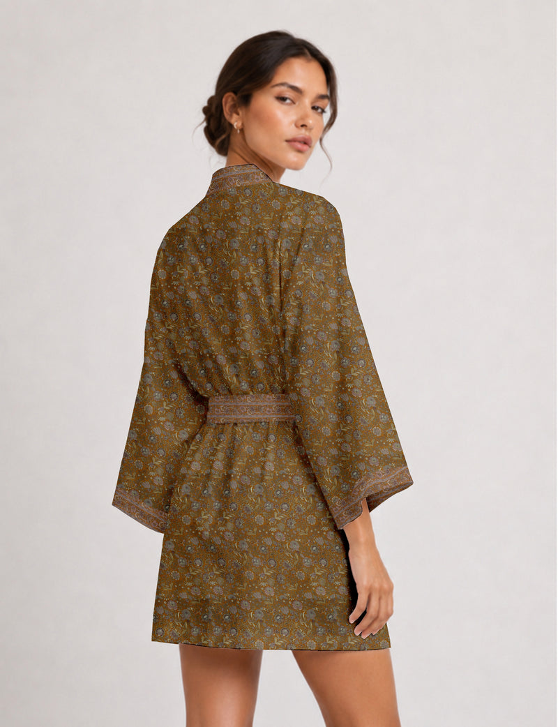 Woman wearing short brown kimono robe with floral pattern and wide sleeves, back view