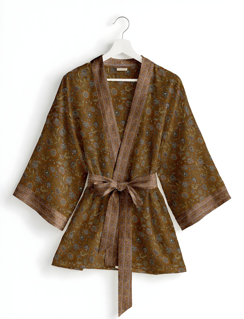 Short kimono robe in brown with floral pattern, wide sleeves, border trim, and self-tie belt, hanging on white hanger
