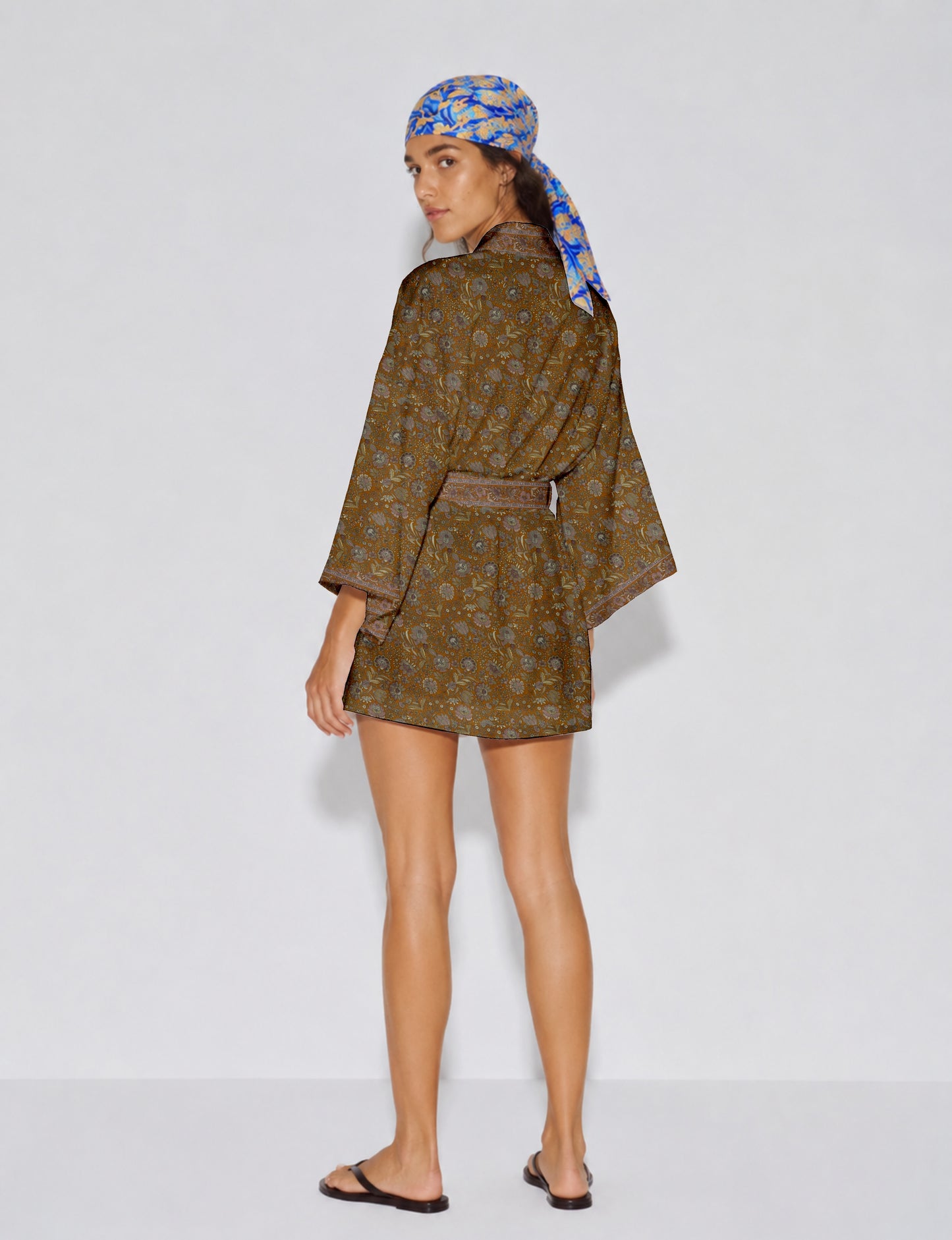 Short kimono robe with wrap front, V-neckline, wide sleeves, waist tie, and concealed skort detail.