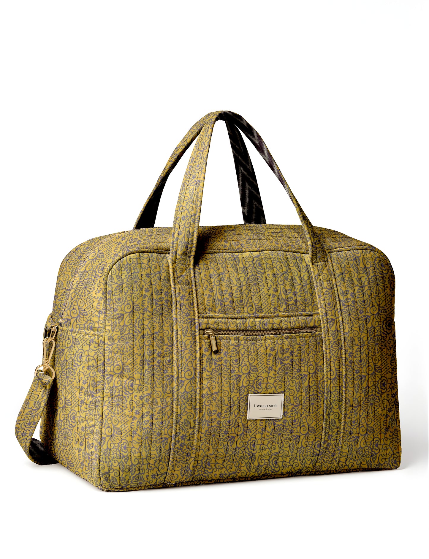 Quilted yellow duffle bag with tropical floral pattern, front zipper pocket, dual handles, and detachable shoulder strap