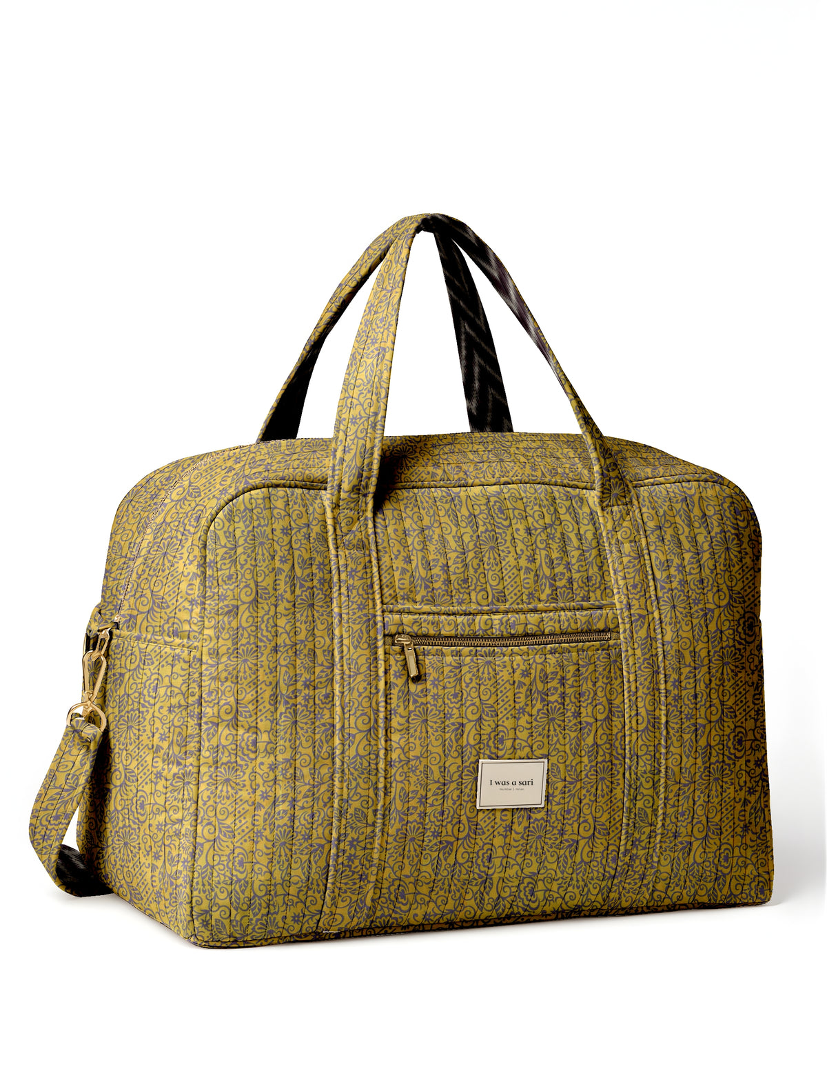Quilted yellow duffle bag with tropical floral pattern, front zipper pocket, dual handles, and detachable shoulder strap