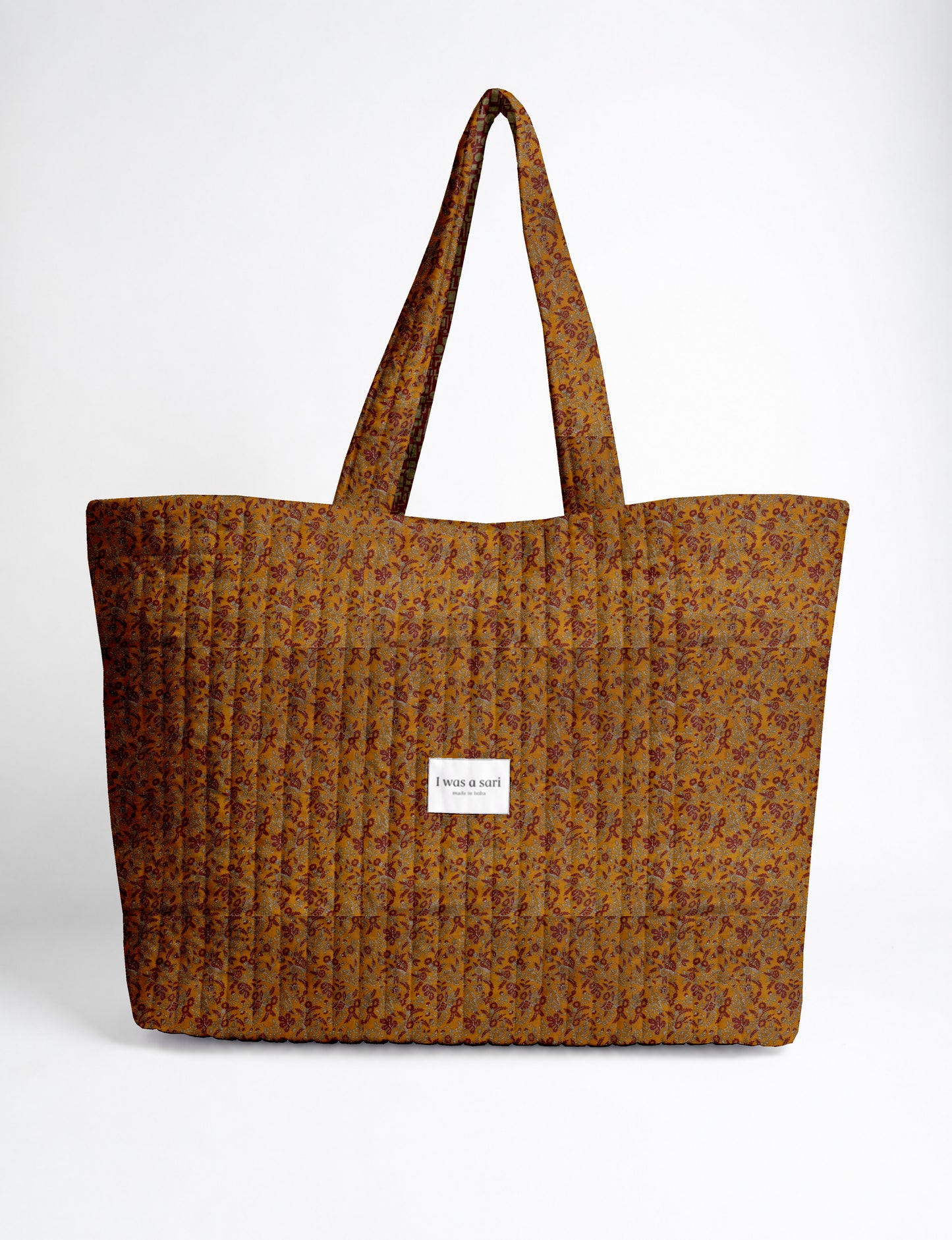 Large quilted beach bag with spacious rectangular design, reinforced shoulder straps, and open-top construction for everyday use and travel.