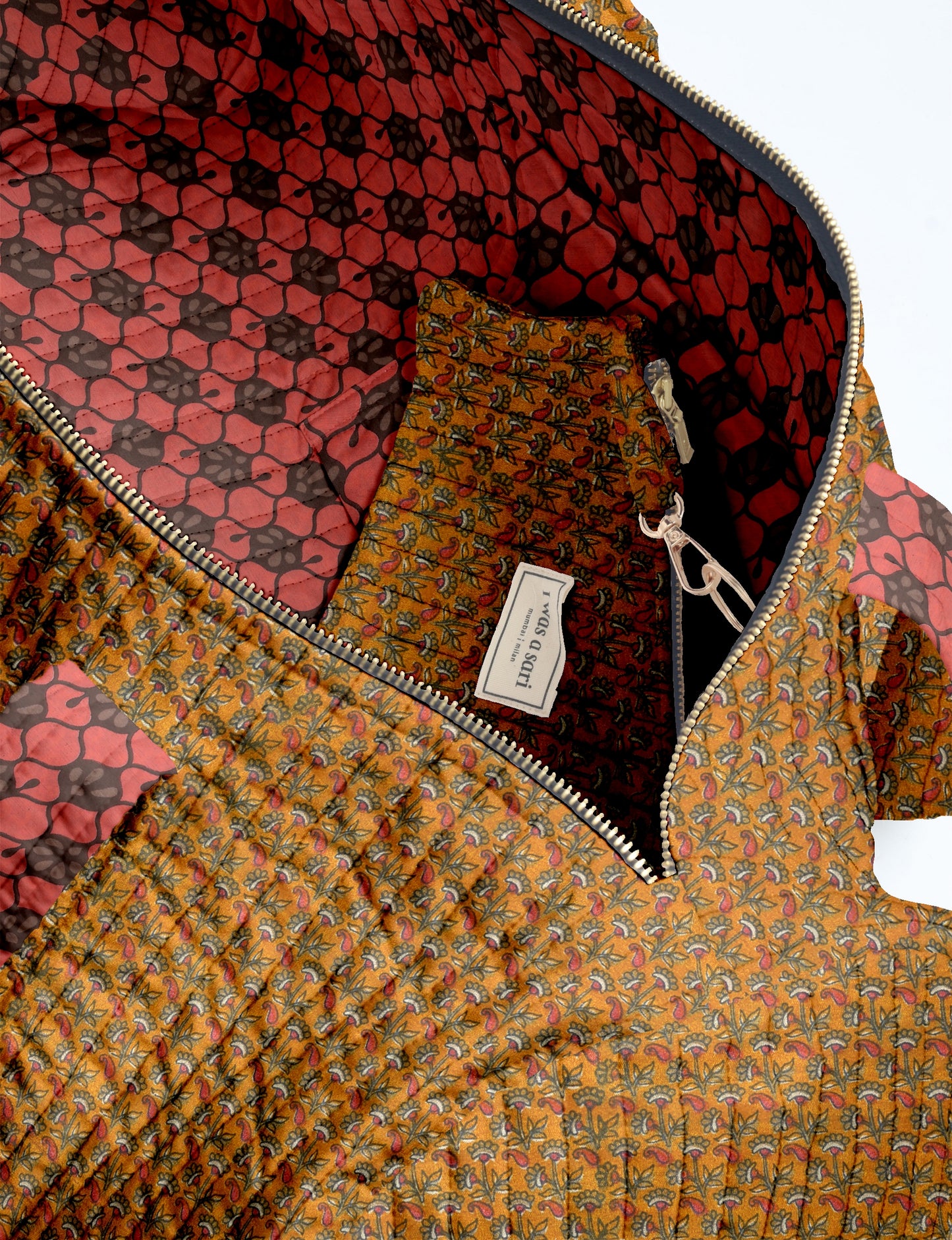 Woman wearing light blue jeans and white sneakers holding a beige quilted bowling bag with micro floral design and front