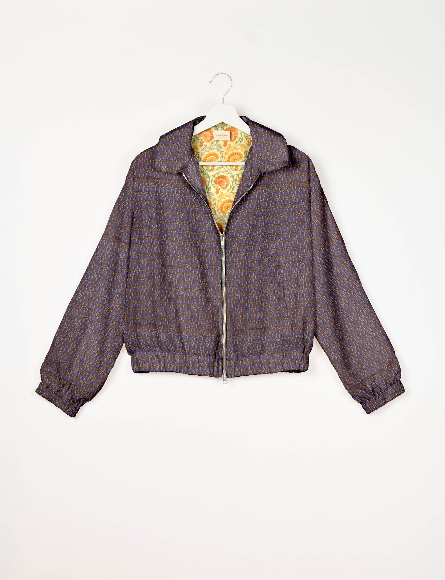 Upcycled Bomber Jacket made from recycled sari materials, featuring a cute cropped shape, elasticated hem and cuffs, and contrast sari print lining. Sustainable apparel promoting eco-friendly fashion and ethical clothing.