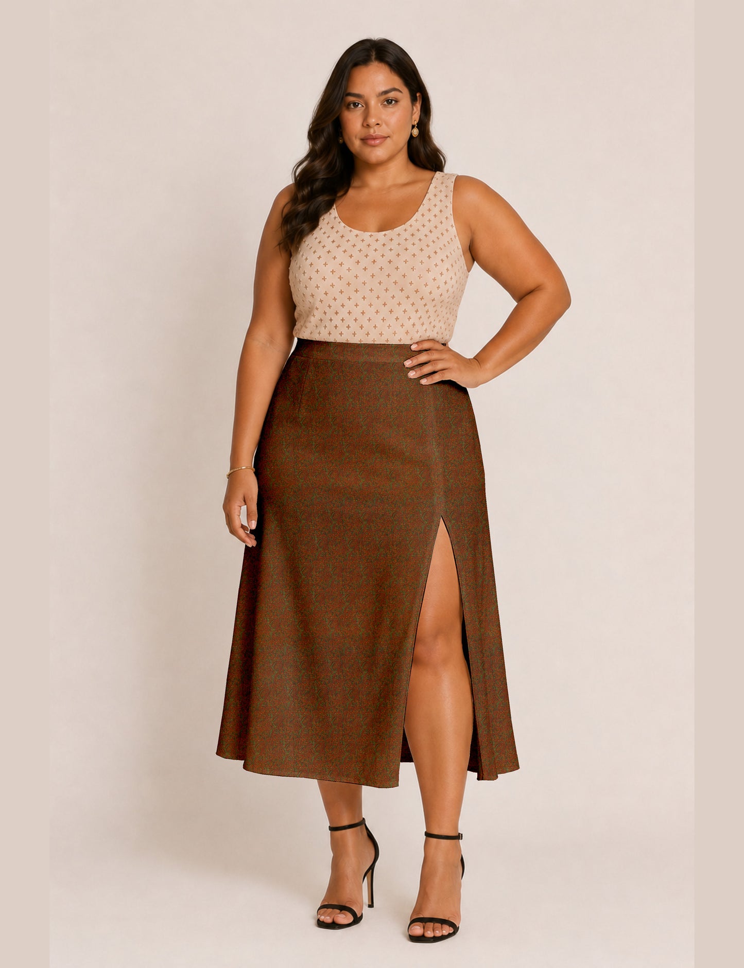 Woman wearing a yellow and black micro patterned A-line skirt with front slit, paired with beige sleeveless top and black