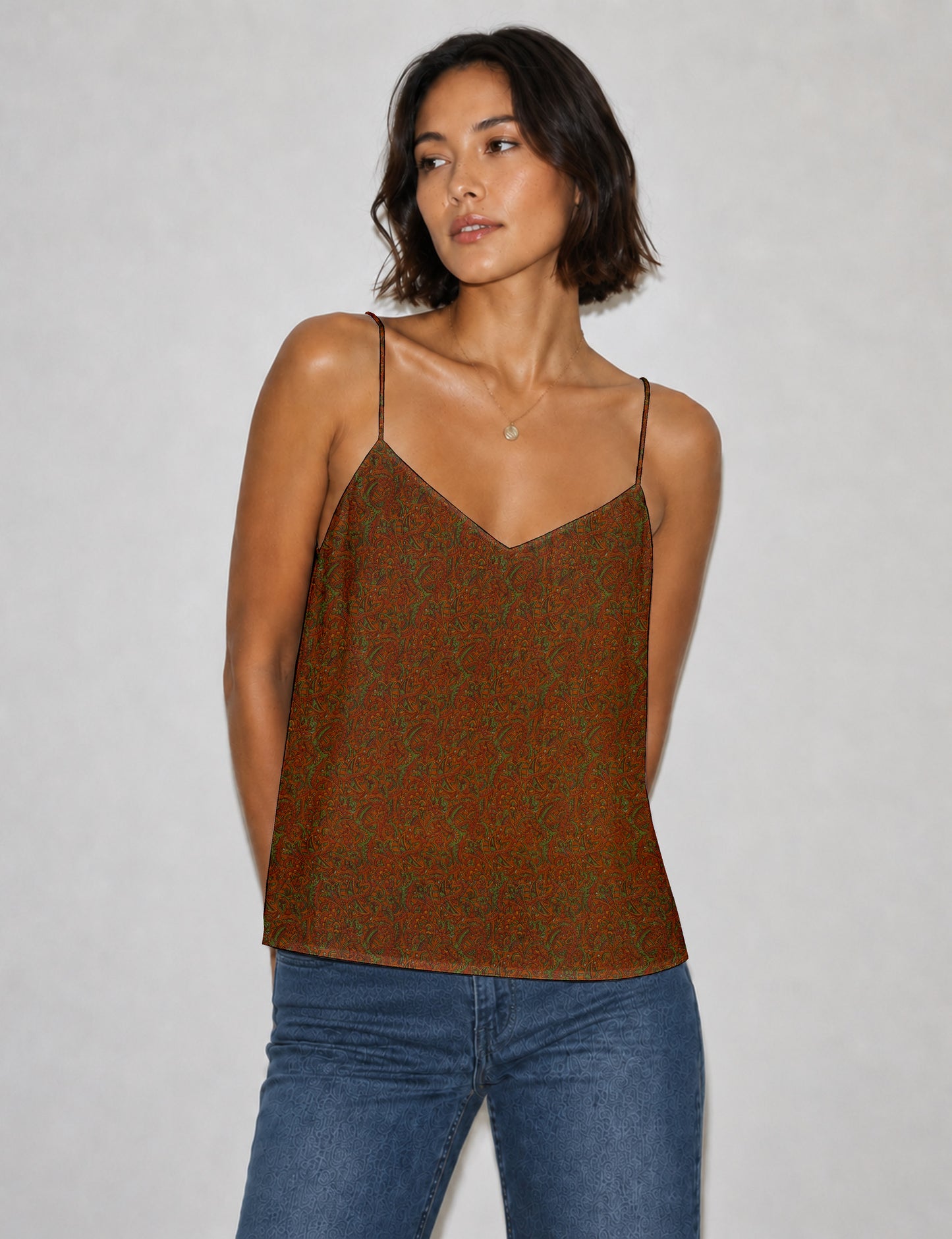 Women's sleeveless slip top with a relaxed straight fit, soft V-neckline, deep V-back, and delicate spaghetti straps.