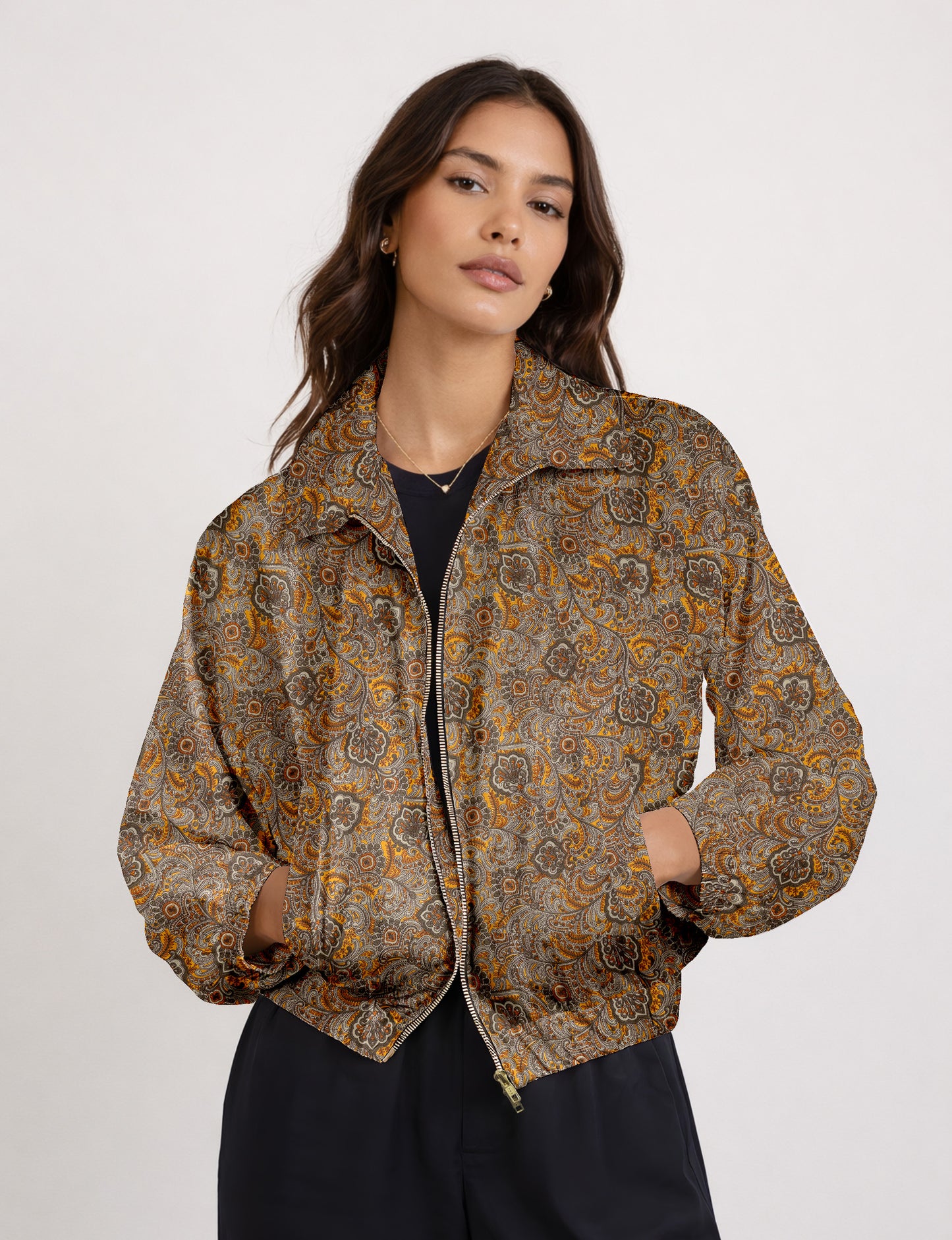 Woman wearing a yellow floral bomber jacket with front zipper, elastic cuffs, and side pockets, shown from front view