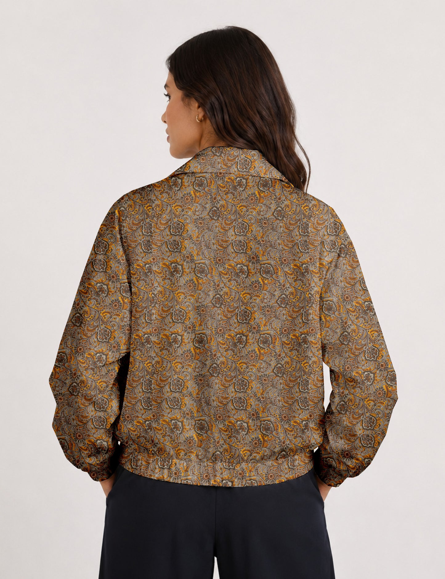 Woman wearing a yellow floral bomber jacket with front zipper, elastic cuffs, and side pockets, shown from front view