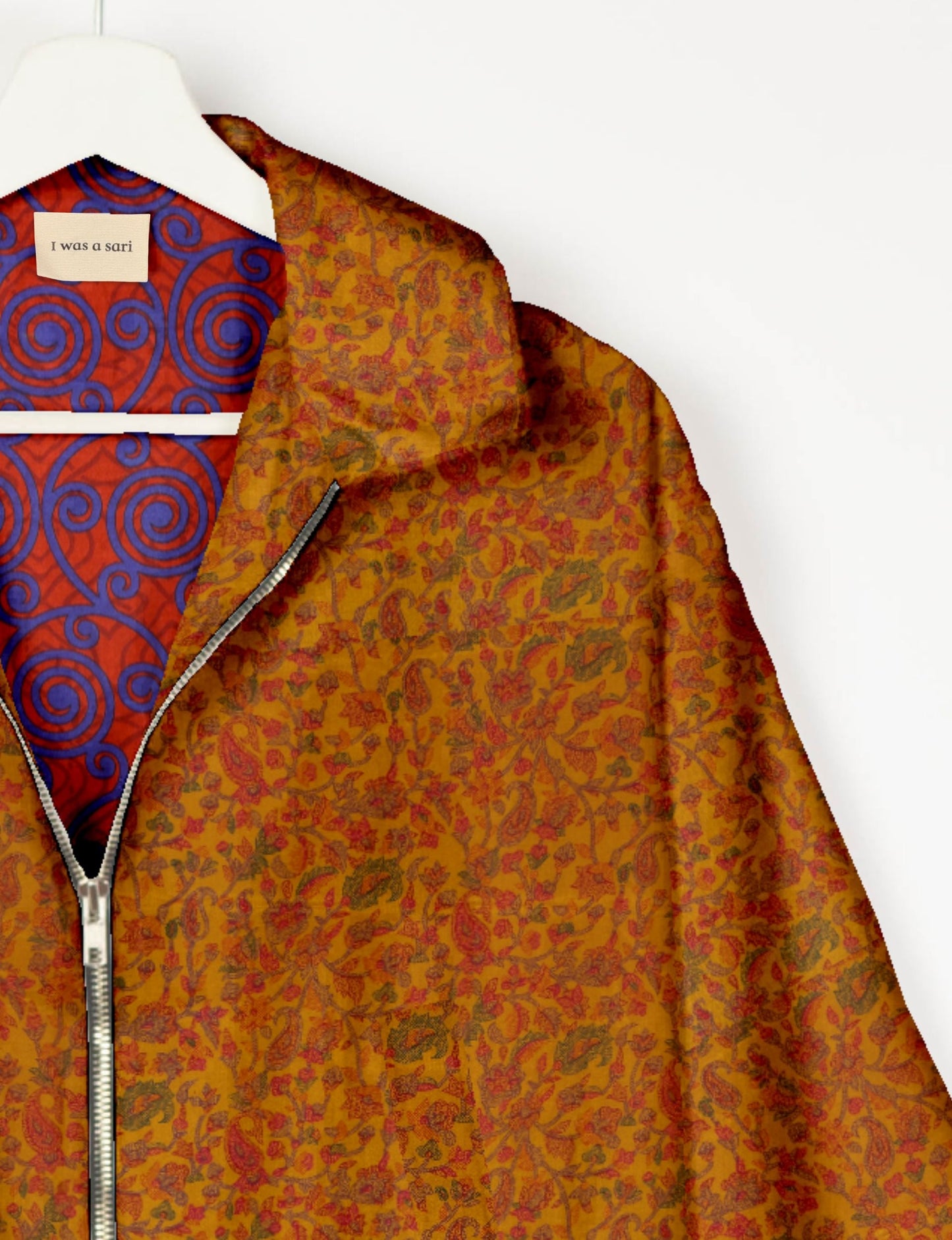 Upcycled Bomber Jacket made from recycled sari materials, featuring a cute cropped shape, elasticated hem and cuffs, and contrast sari print lining. Sustainable apparel promoting eco-friendly fashion and ethical clothing.