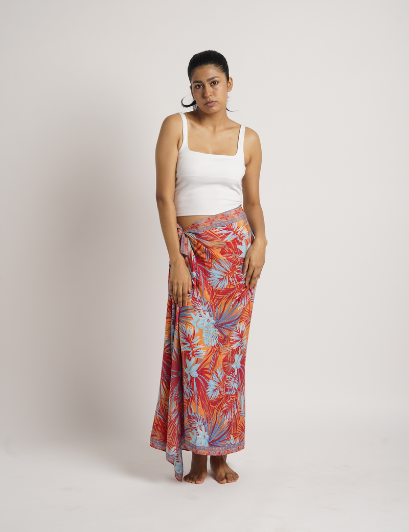 Woman wearing a beige floral pareo tied at the waist, shown from front view