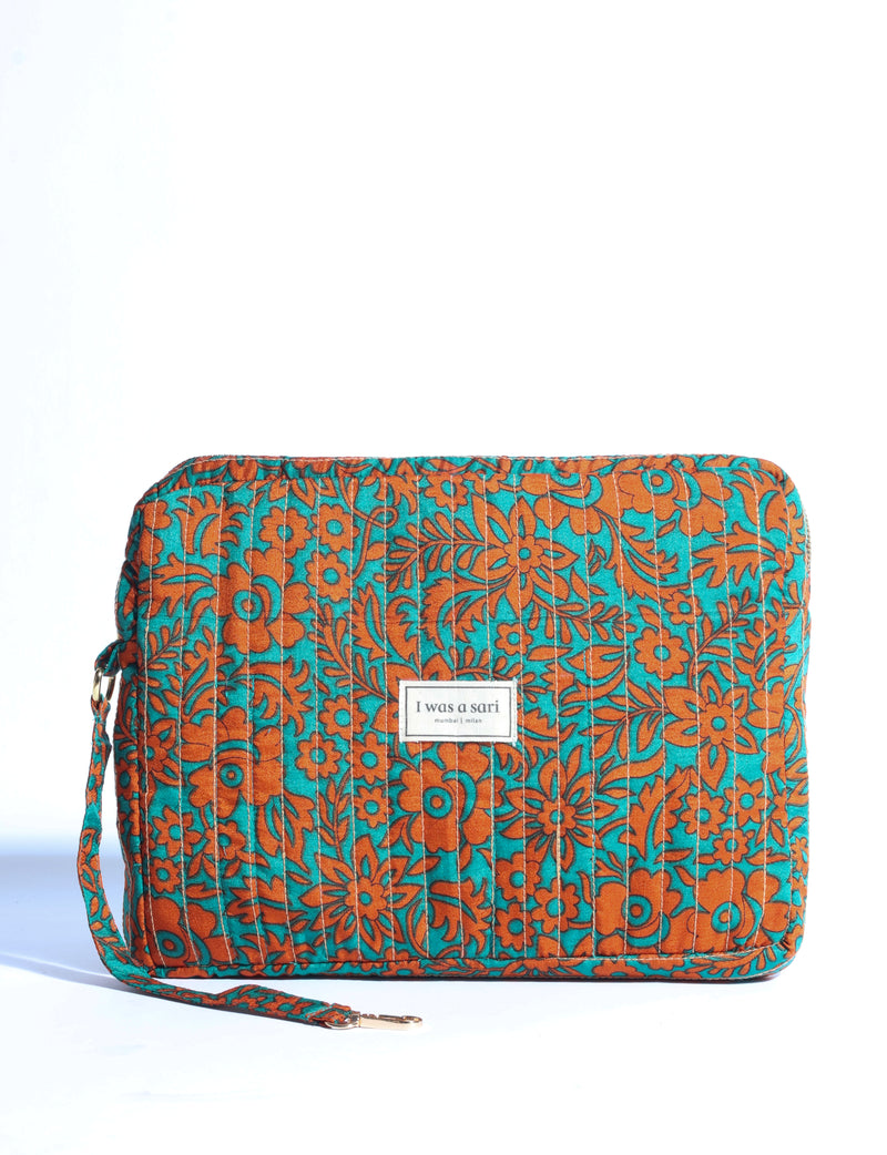 Quilted organizer with orange floral pattern on teal background, rectangular shape, detachable strap, front label "I was a