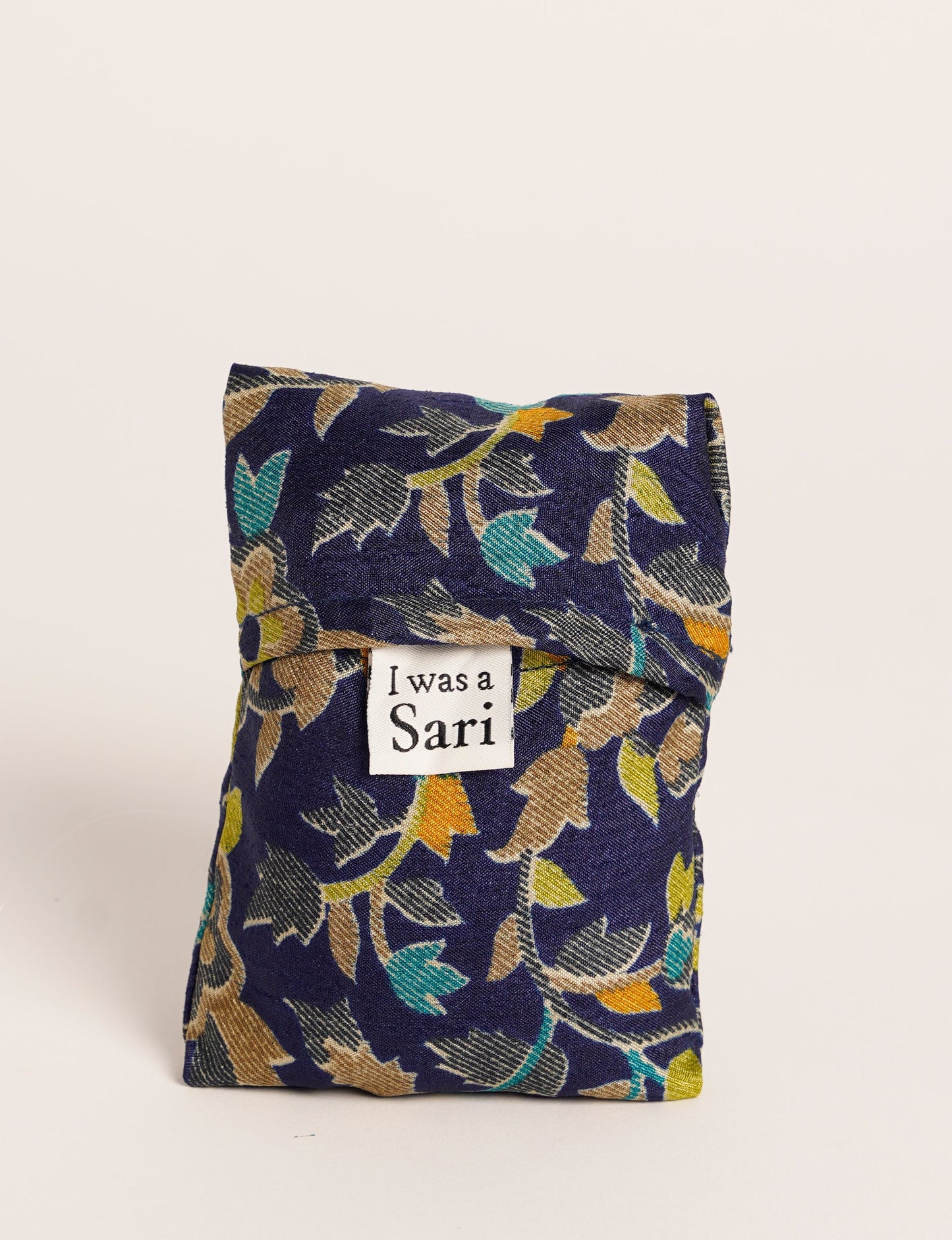 Stay eco-conscious with our Reusable Bag, handmade by Indian artisans from pre-loved saris. Silky and lightweight, this foldaway bag is perfect for your on-the-go lifestyle. Each piece is a unique statement of ethical fashion, embracing sustainability and style.