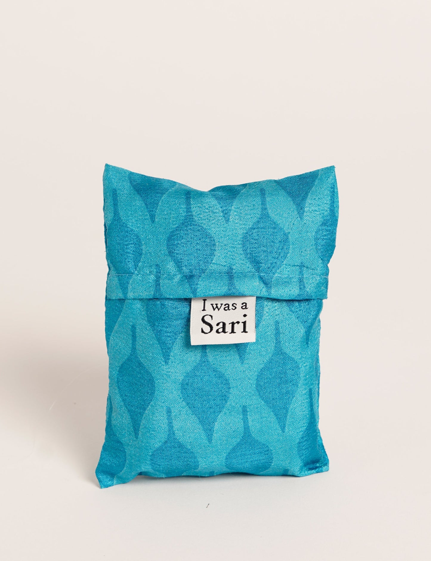 Stay eco-conscious with our Reusable Bag, handmade by Indian artisans from pre-loved saris. Silky and lightweight, this foldaway bag is perfect for your on-the-go lifestyle. Each piece is a unique statement of ethical fashion, embracing sustainability and style.